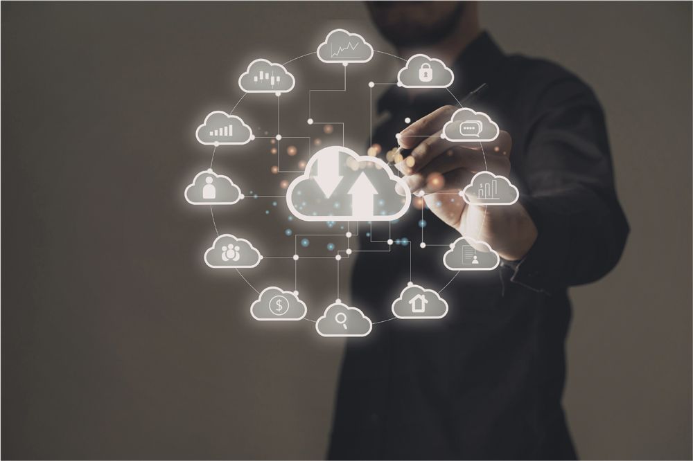 A person in a dark shirt interacts with a glowing, circular digital interface of interconnected cloud computing icons.