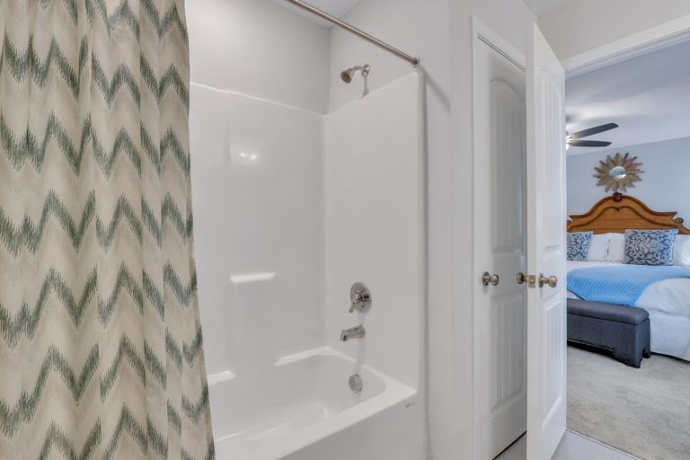 A bathroom with a bathtub and a shower curtain
