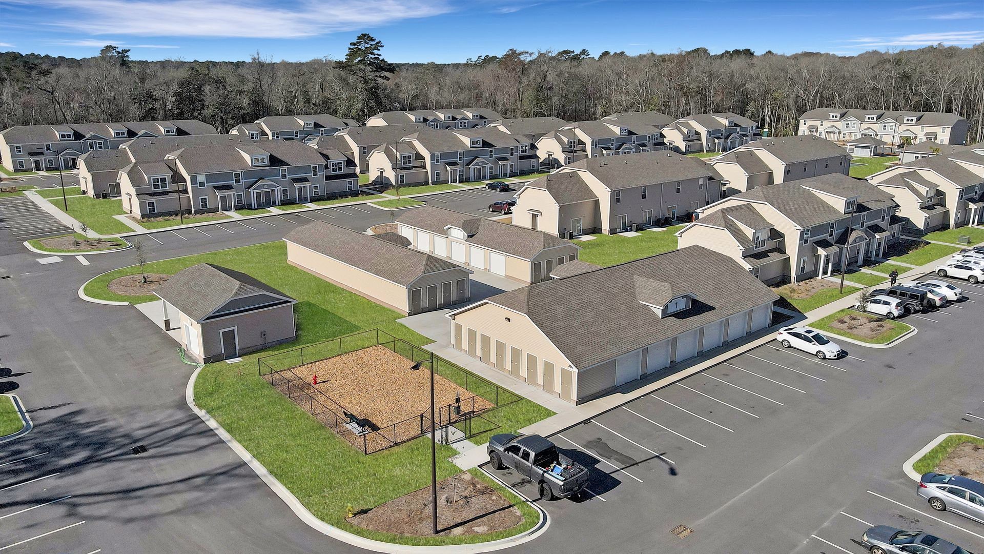 An aerial view of a residential area with lots of houses and a parking lot.