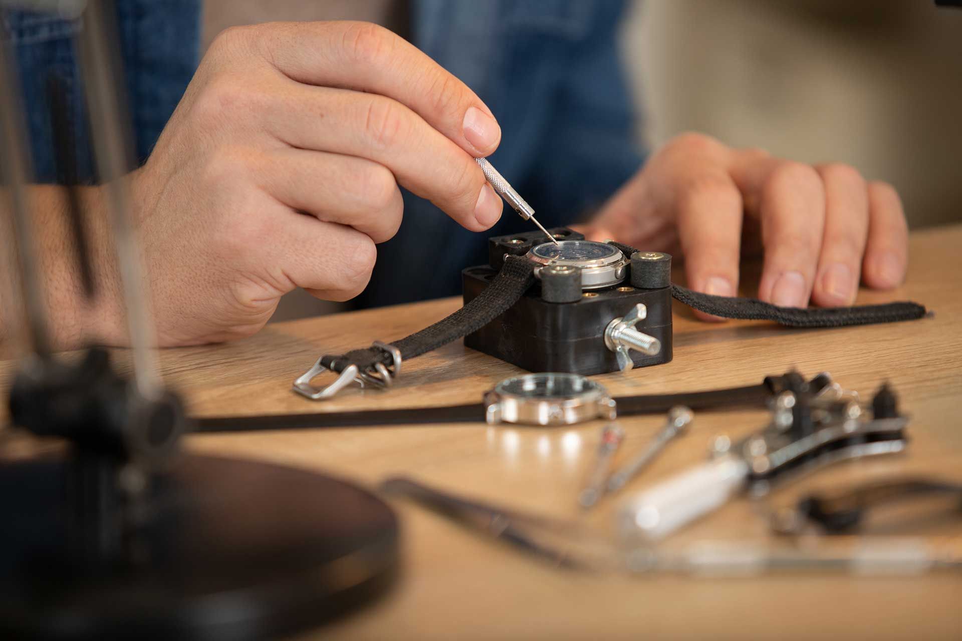 close cropped view of wrist watch being repaired