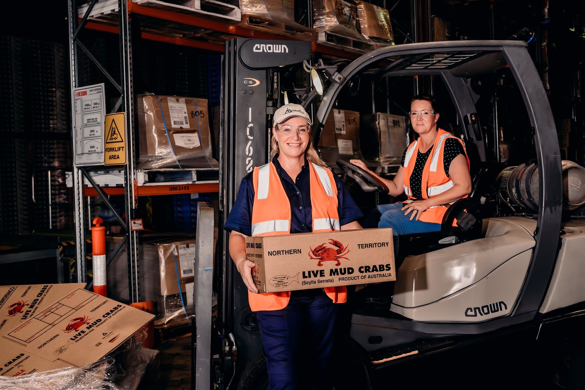 Worker Holding A Package — Master Bait & Tackle in Palmerston, NT