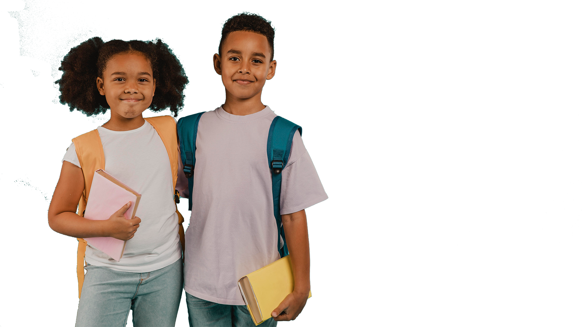Two students standing side by side, smiling. One has a backpack and book, other has book and backpack.