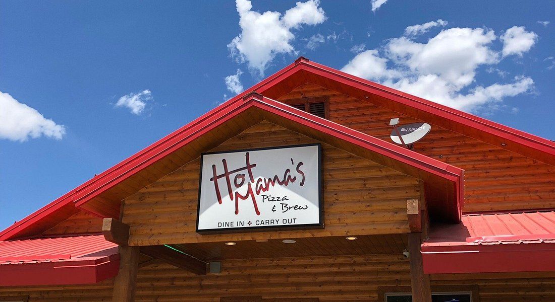 Hot Mama's Place restaurant with red roof and sign against a blue sky.