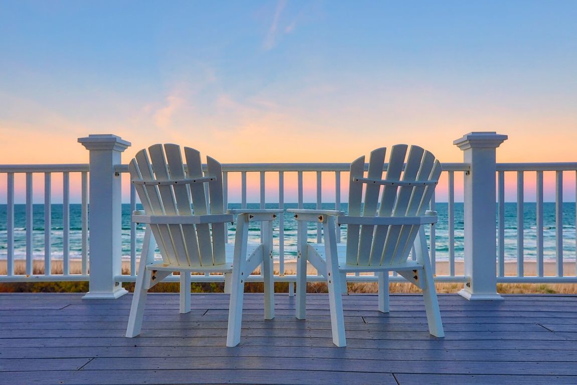 beach chairs on the deck at sunset