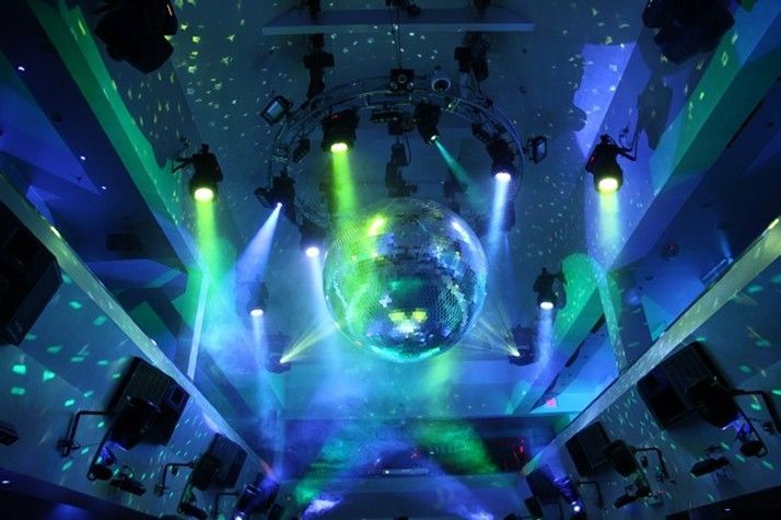 A disco ball is surrounded by a bunch of lights in a room.