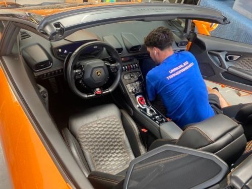 Mason working on the interior of a Lamborghini