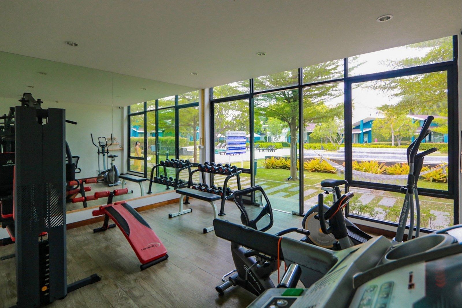 Gym with fitness equipment, large windows, and an outdoor view.