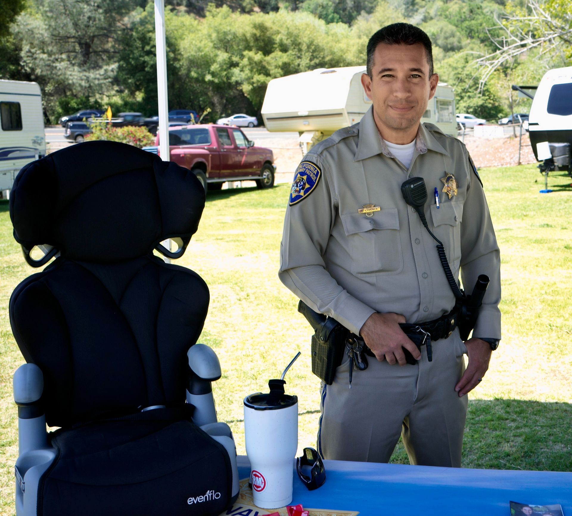 a sheriff next to a car seat in a booth