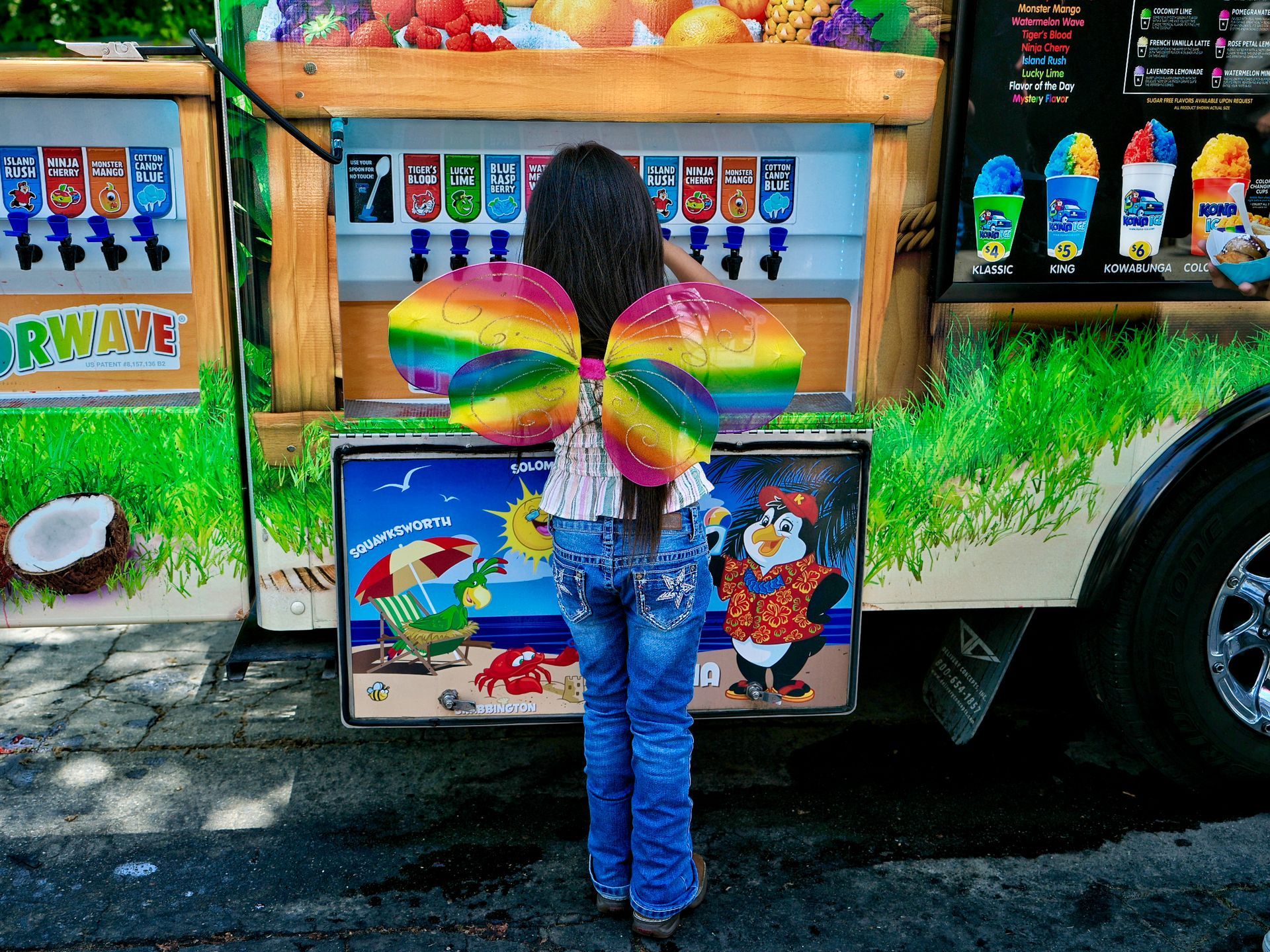 a girl wearing rainbow butterfly wings