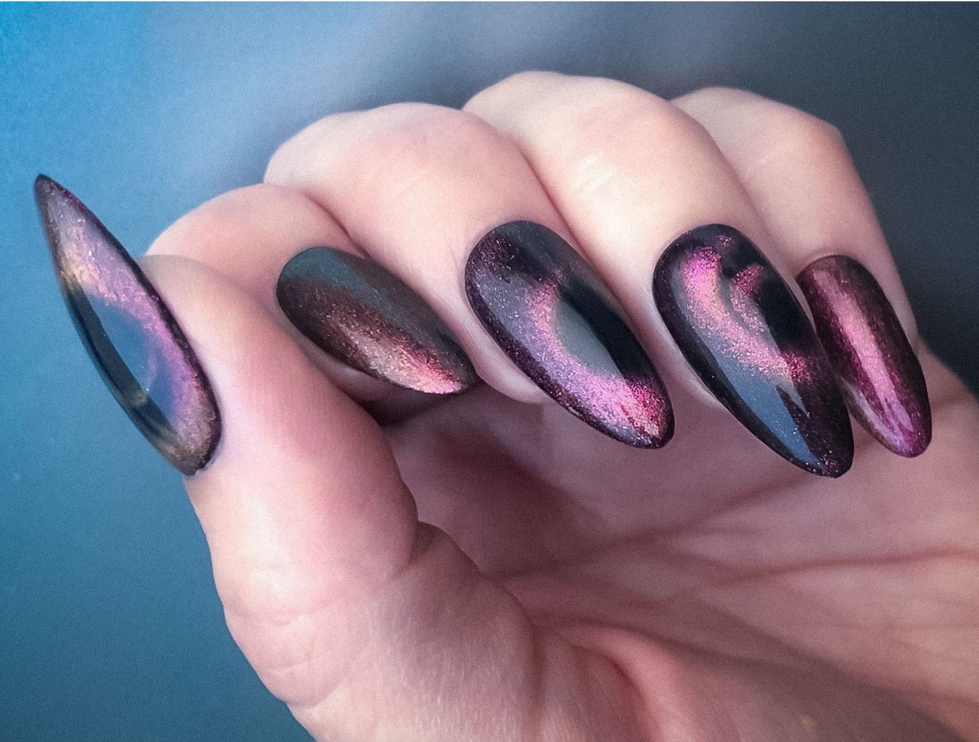 A close up of a person 's hand with long nails