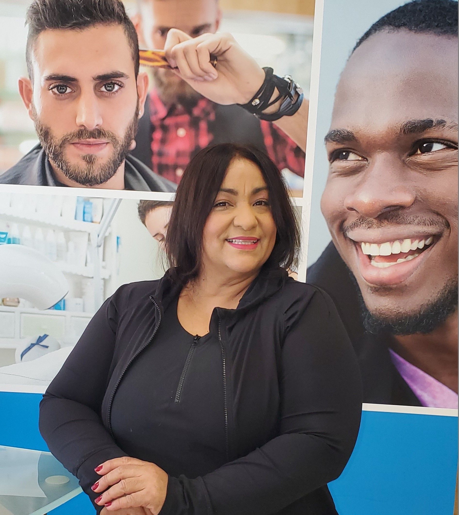 A woman is standing in front of a collage of men 's faces.