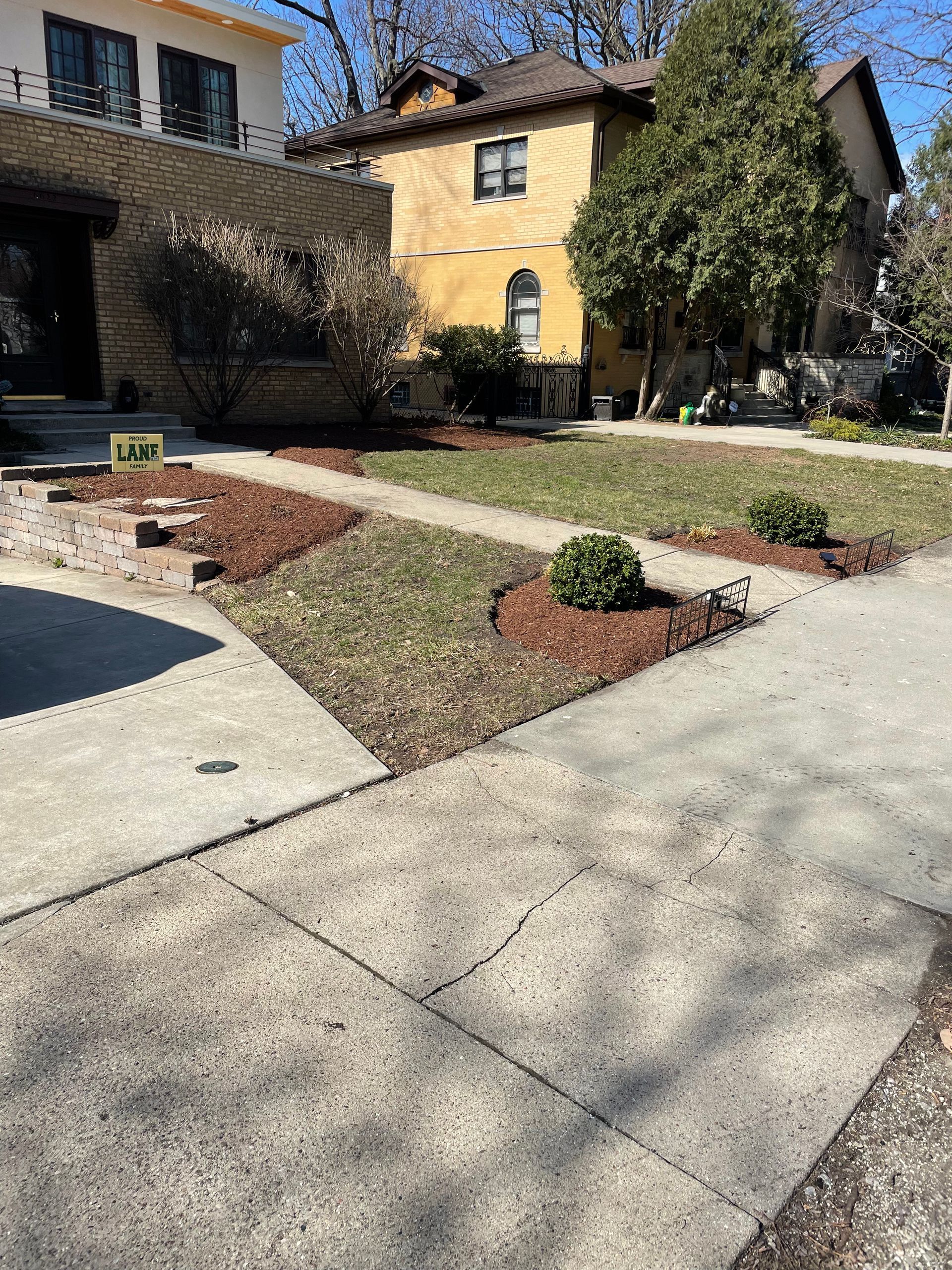 A house with a lawn in front of it and a sidewalk in front of it.