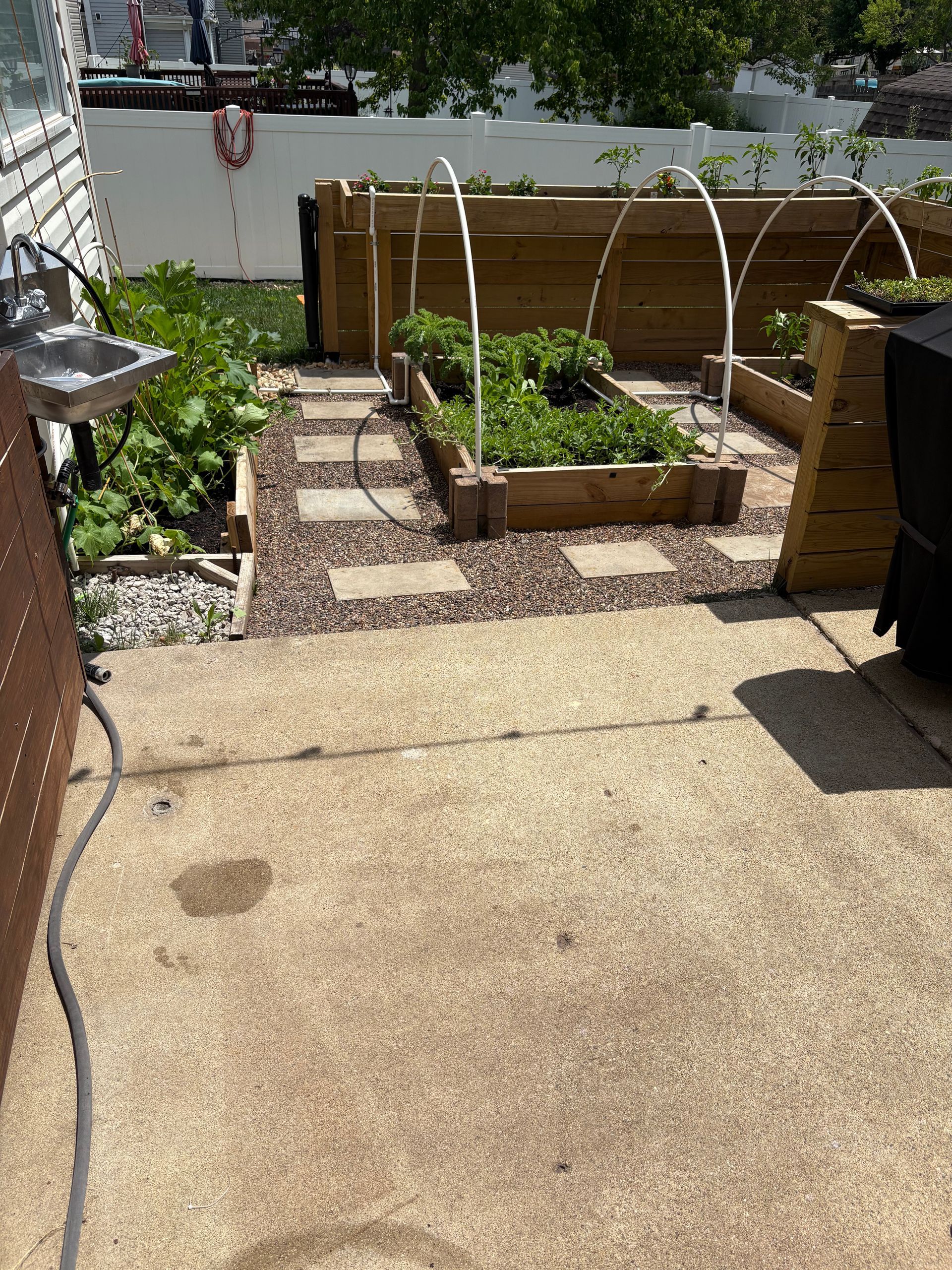 A patio with a sink and a hose in it