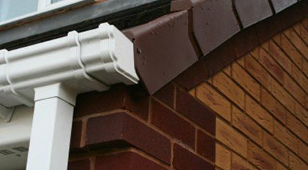 neat, white guttering and square section downpipe