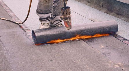 torching on a roll of roofing felt