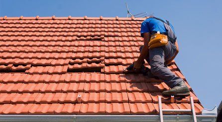 roofer fitting plastic roof tiles