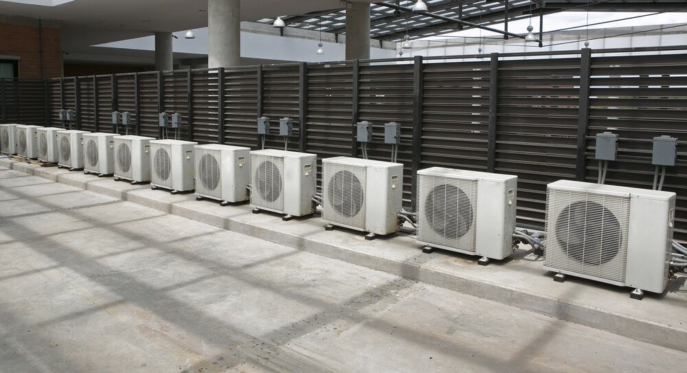 A row of air conditioners are lined up in a room — Gleeson's Air Conditioning in Port Macquarie, NSW