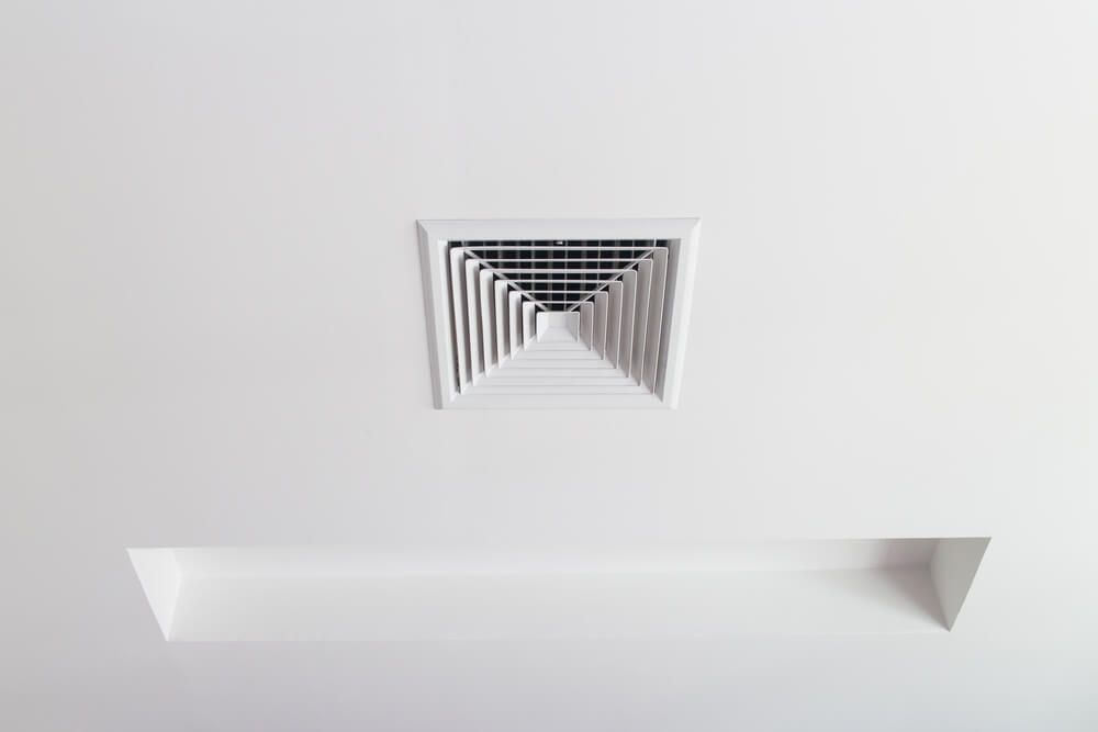 A square air vent on the ceiling of a room — Gleeson's Air Conditioning in Port Macquarie, NSW