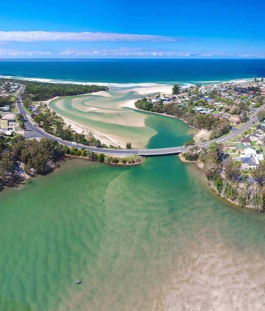 A Road going over the top of a river with the ocean in the background — Gleeson's Air Conditioning in Lake Cathie, NSW