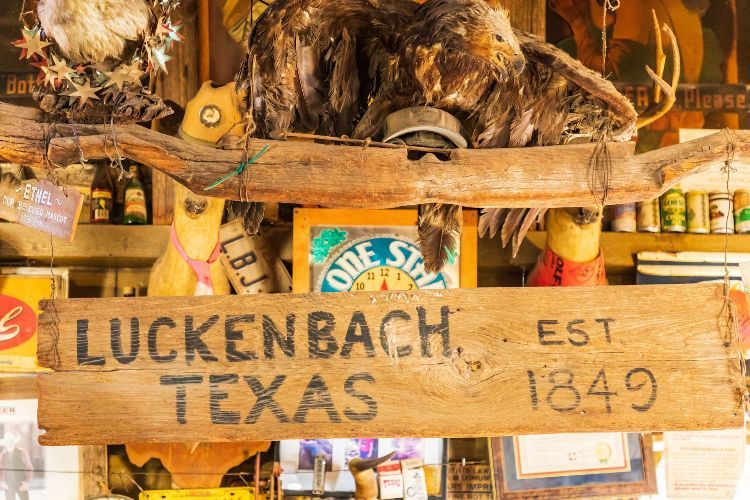A wooden sign that says luckenbach texas on it