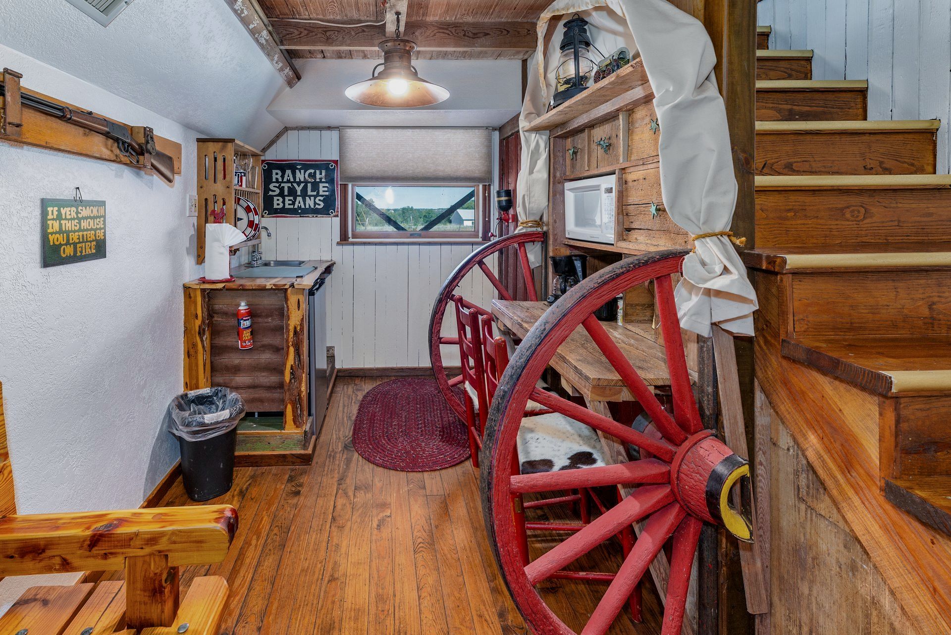 There is a red wagon wheel in the middle of the room.