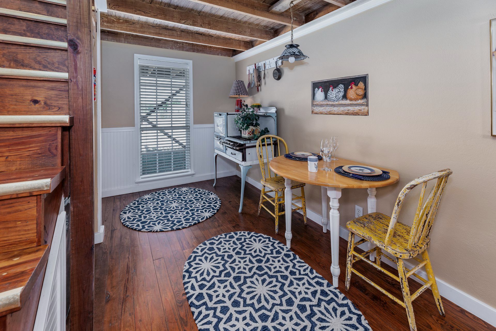 There is a table and chairs in the room.