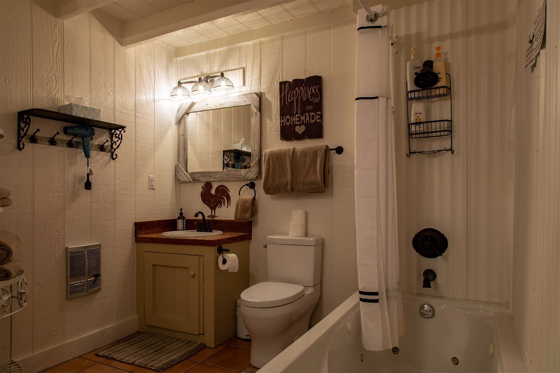 A bathroom with a toilet , sink , and bathtub.