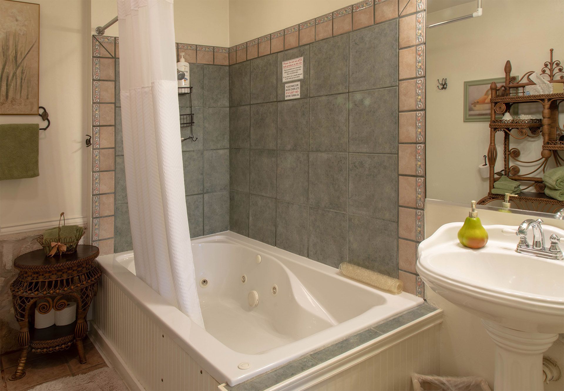 A bathroom with a jacuzzi tub and a sink