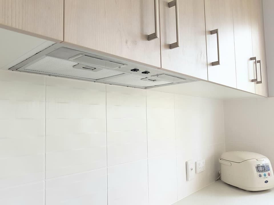 A Kitchen With White Cabinets and a Stove Top Oven — NGK Constructions In Freshwater, QLD