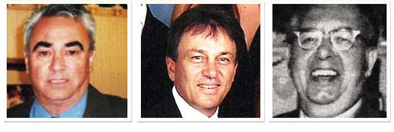 A family is posing for a picture in the woods.