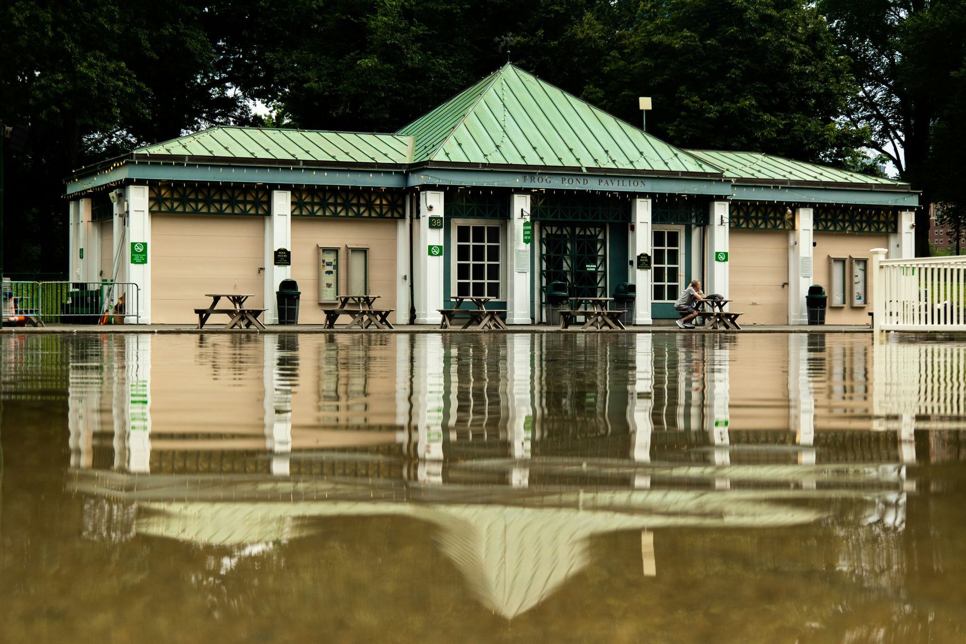 A man is wrapping his wrist with a red bandage.