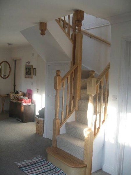 straight staircase by white wall