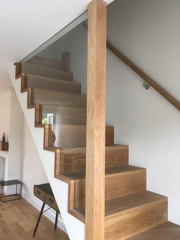 brown, wooden staircase on white wall