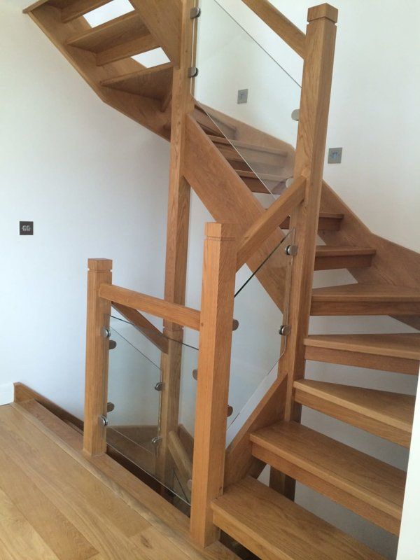 twisted wooden staircase on white wall