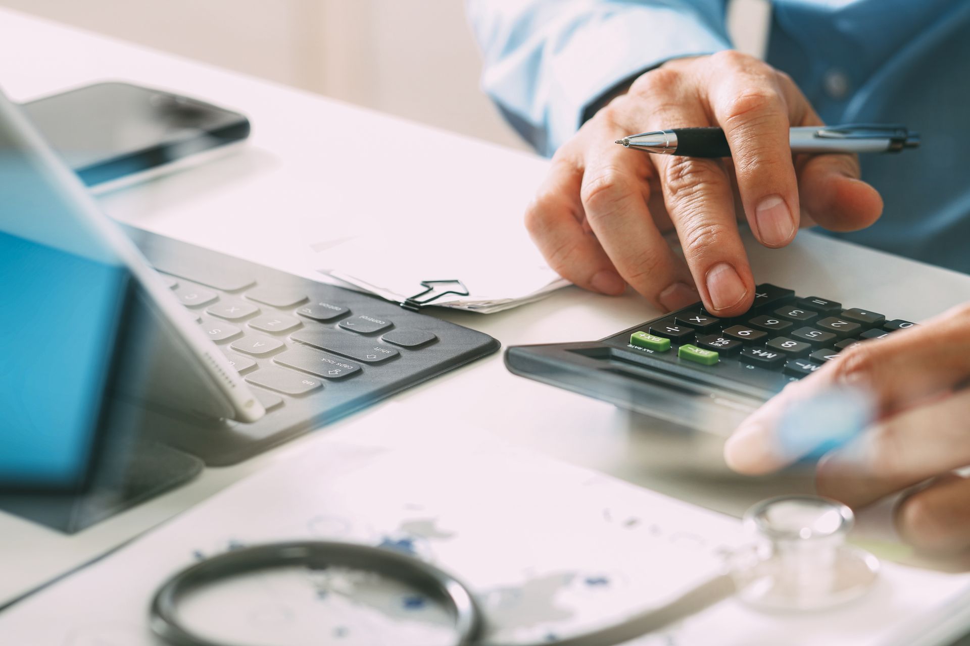 Person with notebook and computer making notes