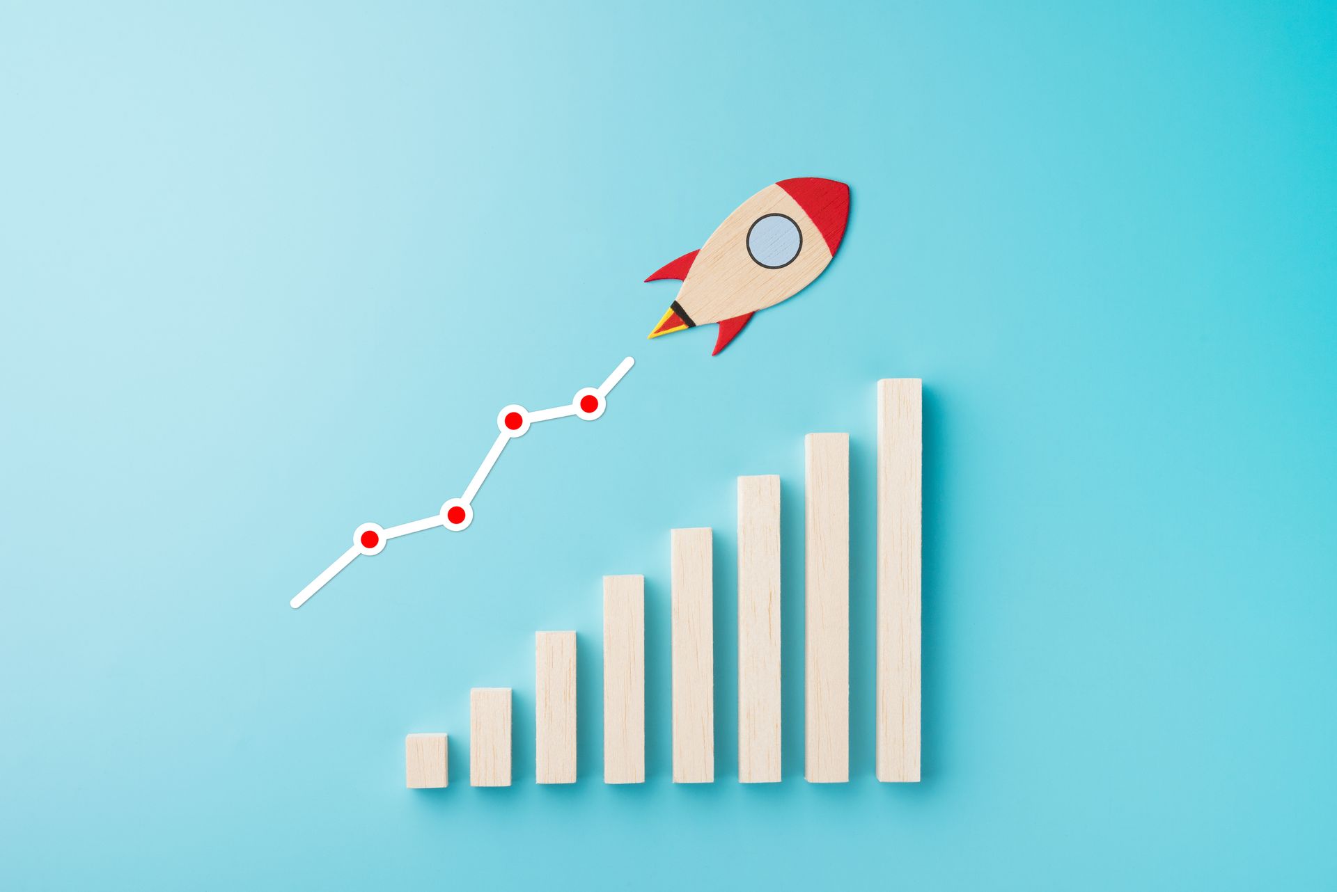 a rocket is flying over a graph on a blue background .