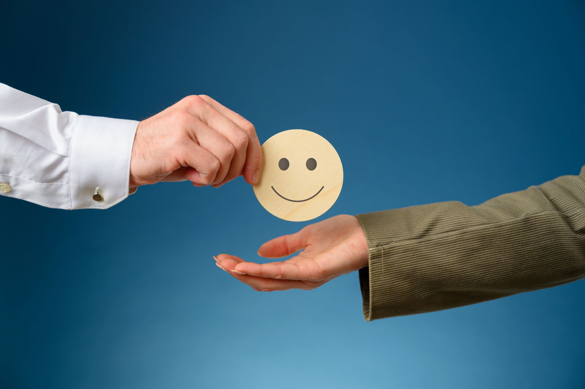 A person is giving a smiley face to another person.