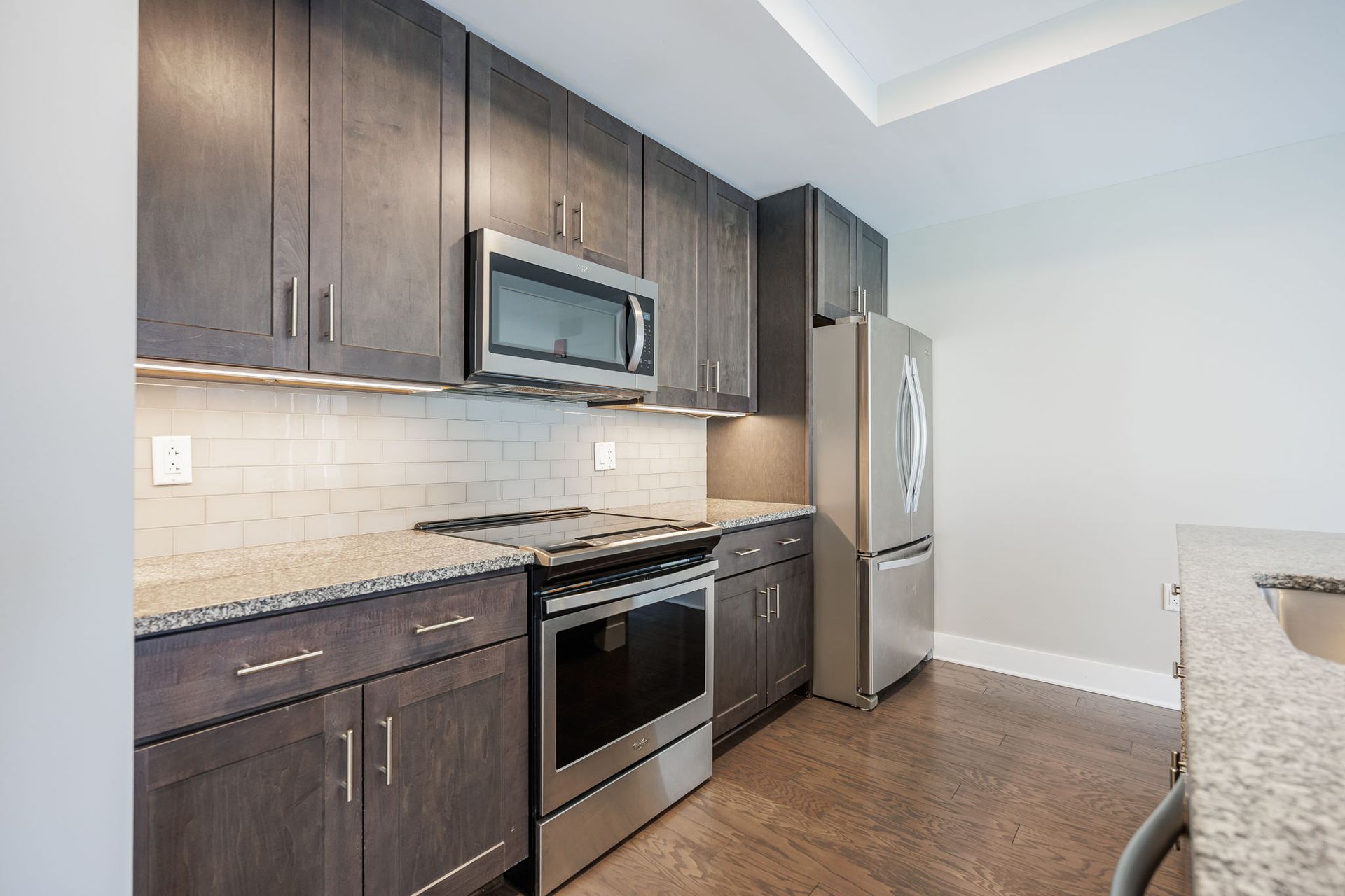 Kitchen with modern backsplash and stainless steel appliances