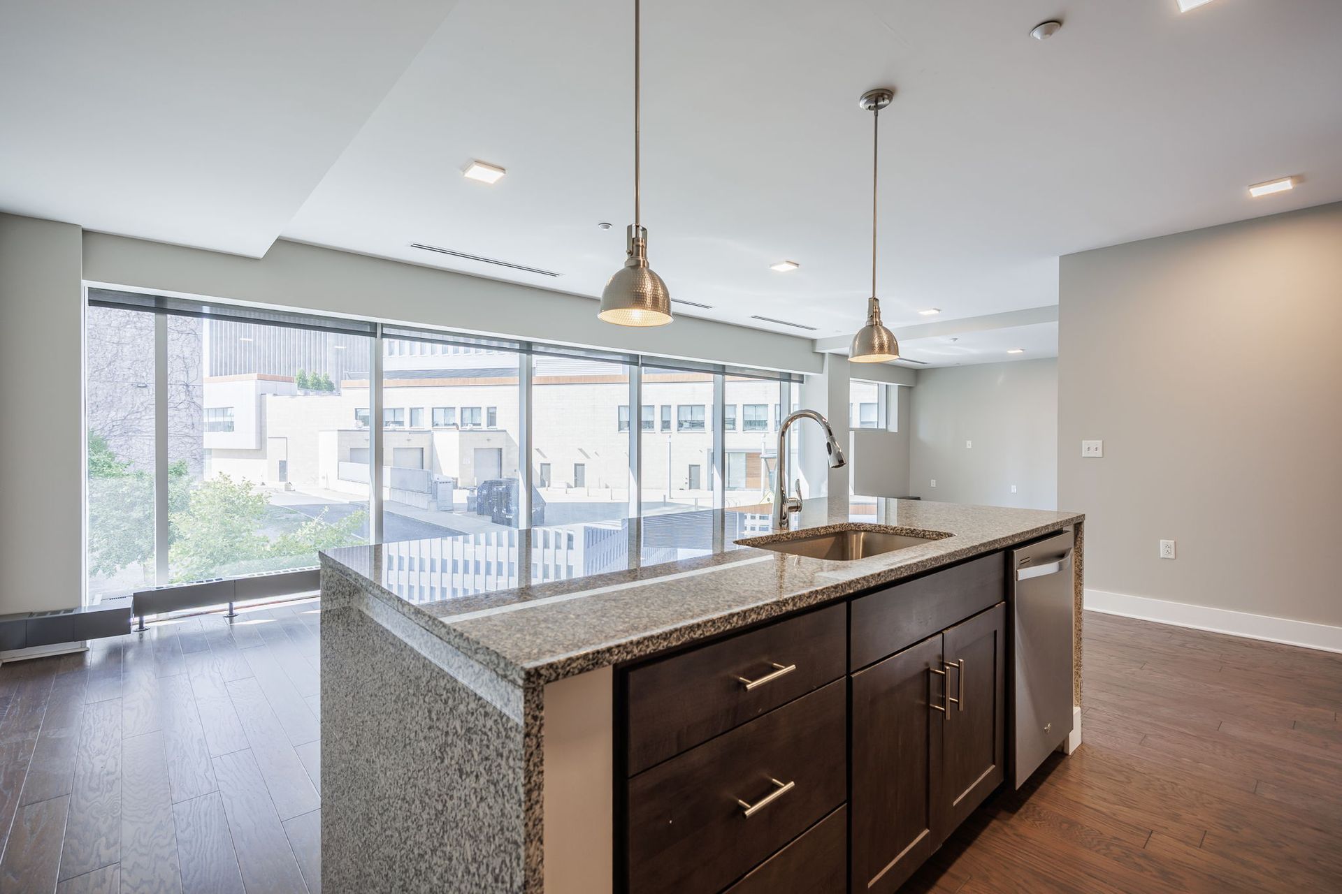 Open concept kitchen and living room with large windows 