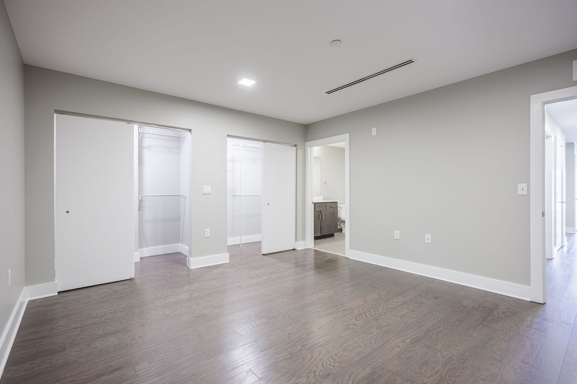 Modern bedroom with two large closets and an en suite bathroom
