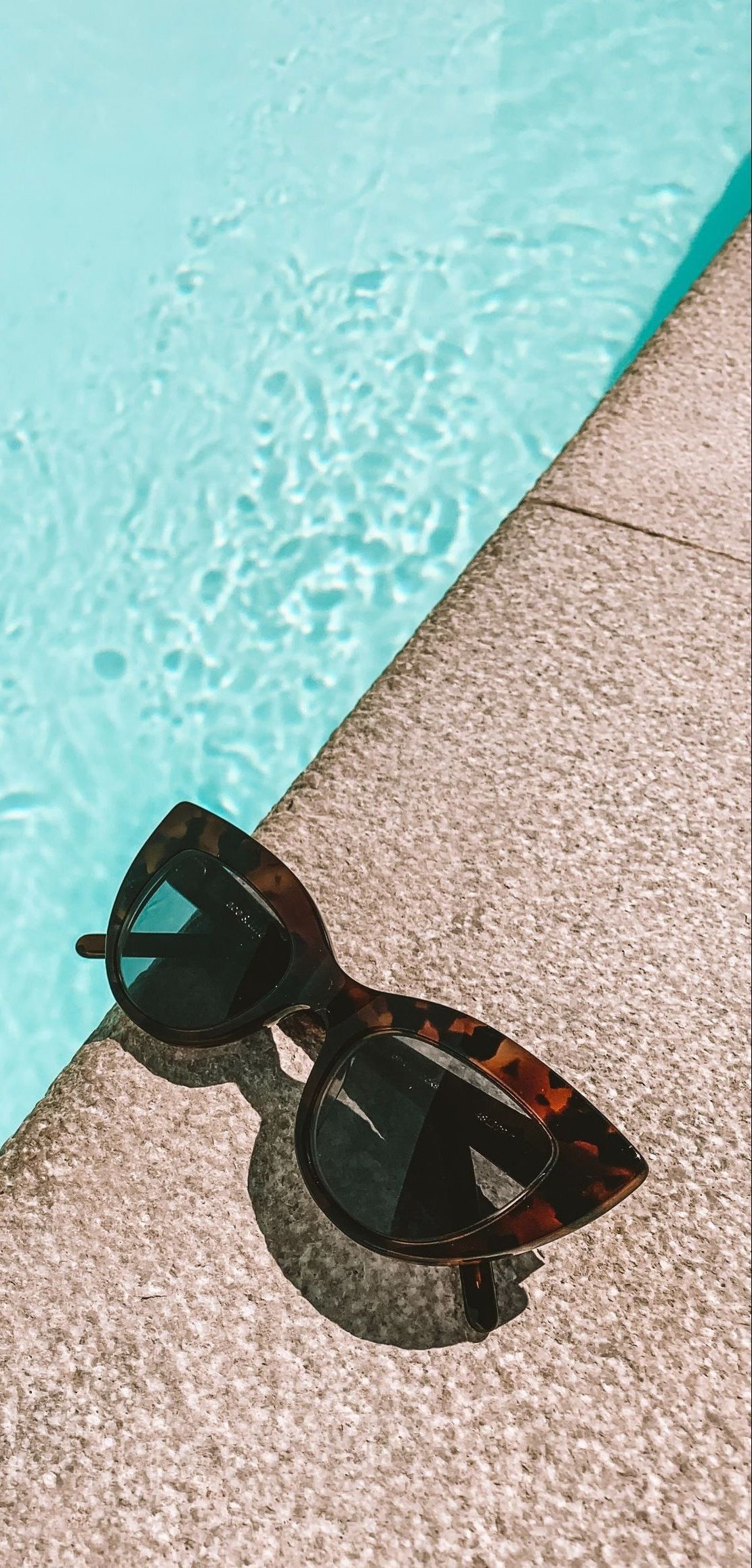 sunglasses by a pool