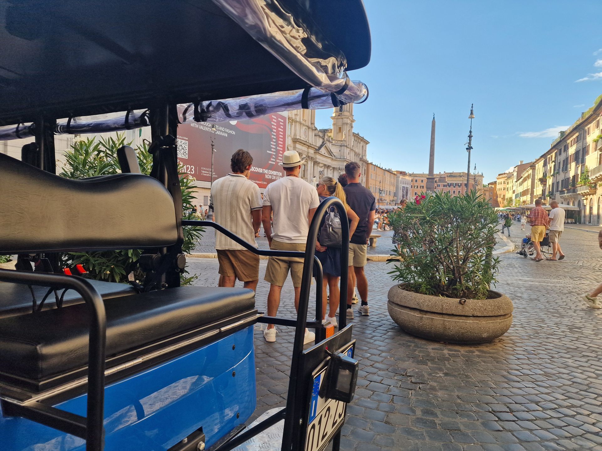 St. Peter's Basilica in Vatican City, seen from afar, with its iconic dome and framed by trees.