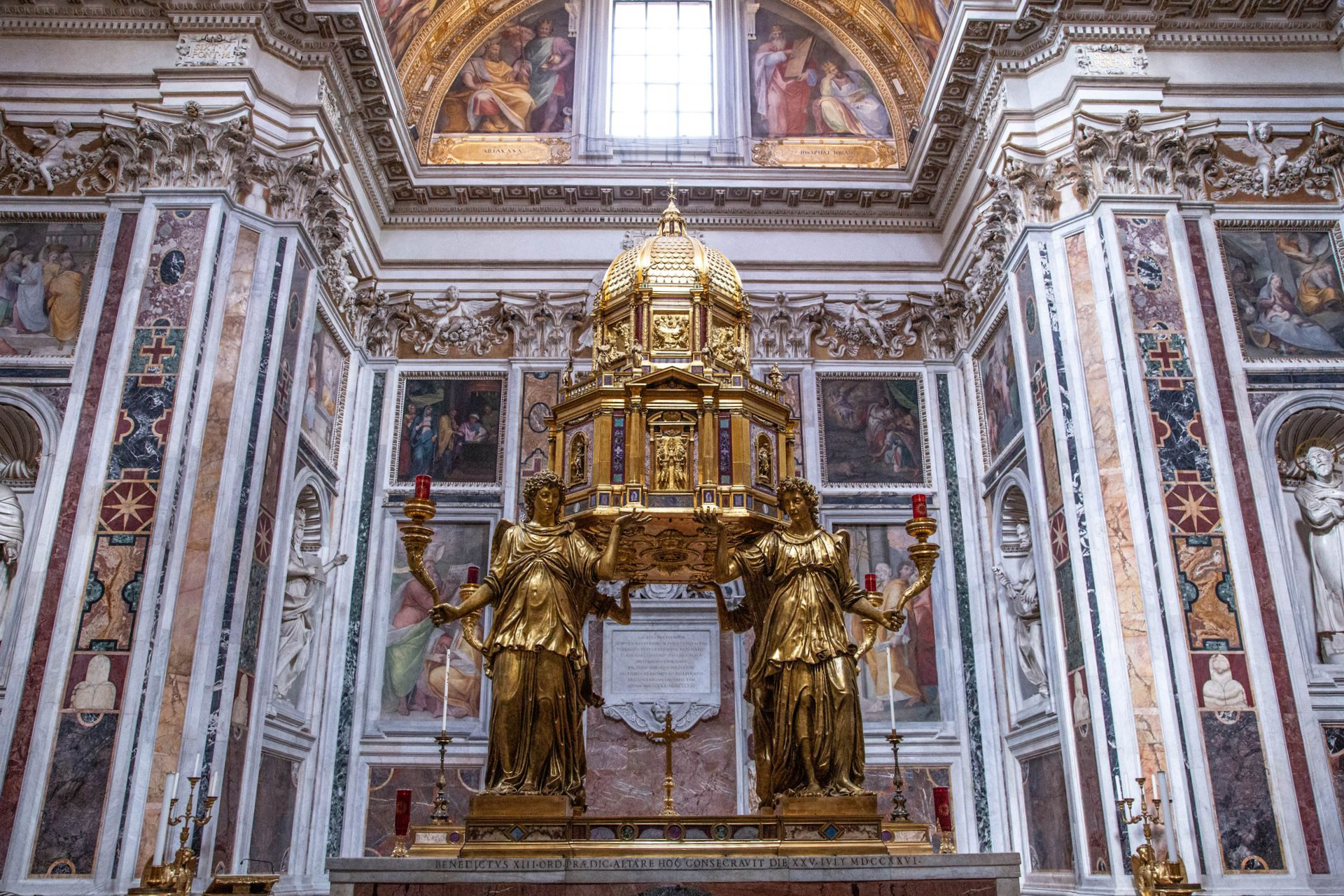 Cityscape of Rome, Italy, with historic buildings, domes, and warm sunlight.
