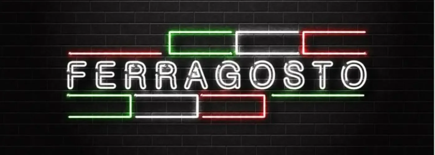 Neon sign for Ferragosto, Italian flag colors on black brick wall.