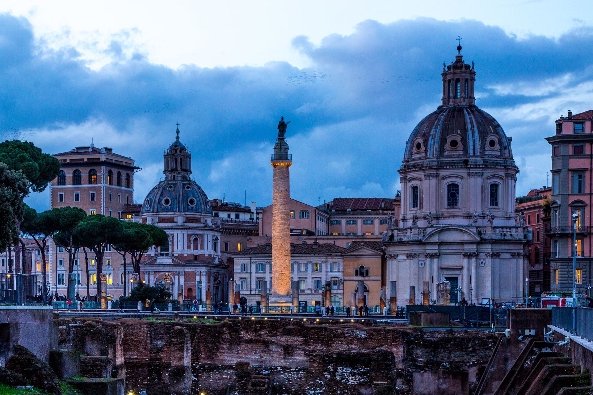 Spanish Steps and fountain in Rome, Italy, illuminated at dusk.