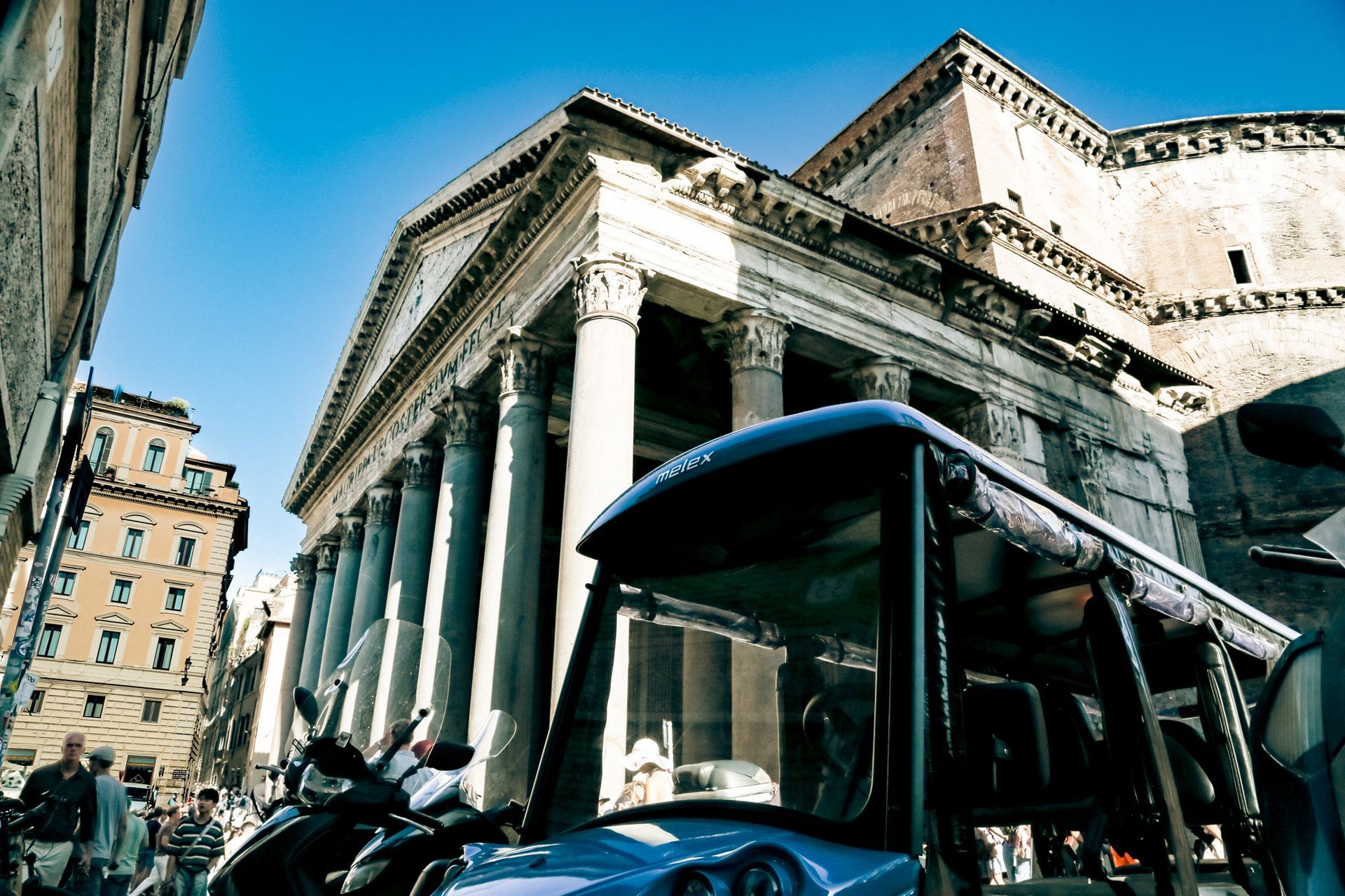 Pantheon behind golf cart in Rome historic center