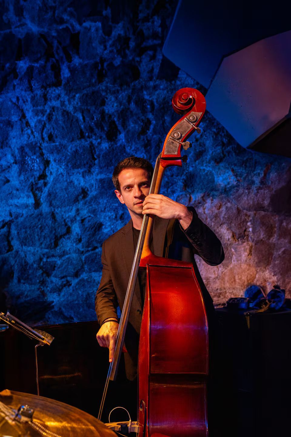 Woman with yellow backpack takes photo of Arch of Constantine, Rome.