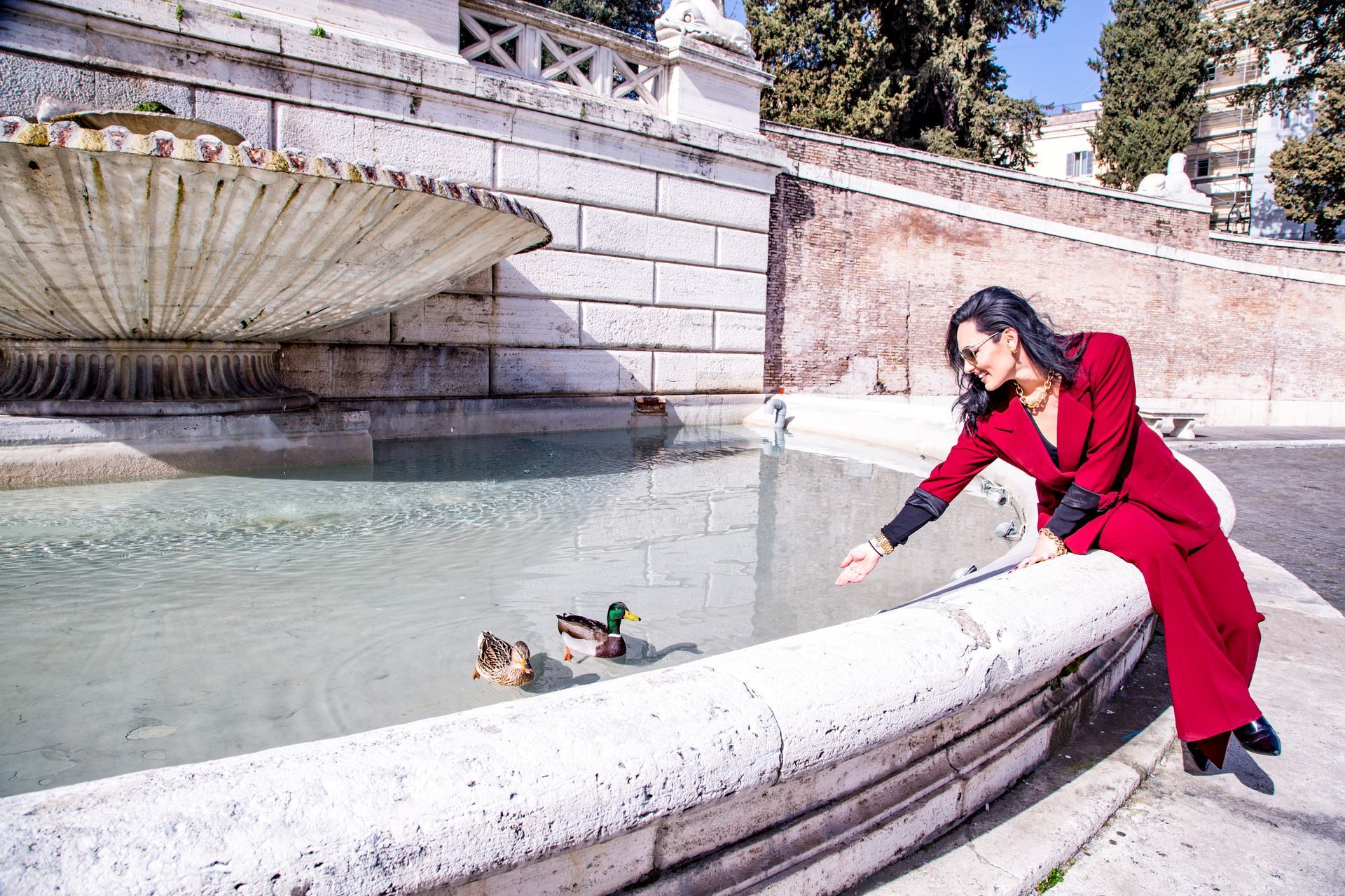 Spanish Steps and a fountain in Rome. Buildings flank a wide staircase; the fountain features a sculpted boat.