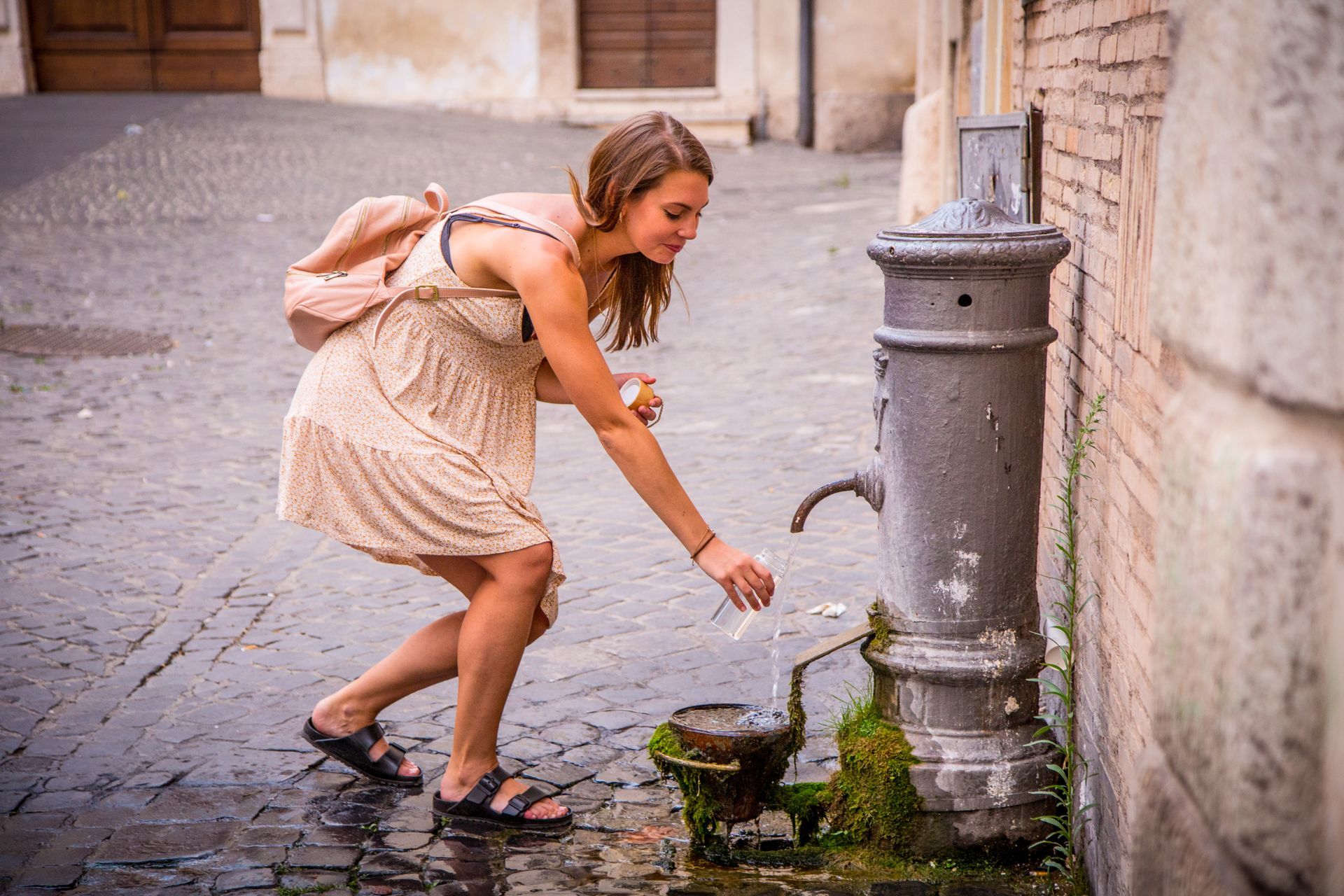 Girl drinking water from a nasone in the Jewish Ghetto
