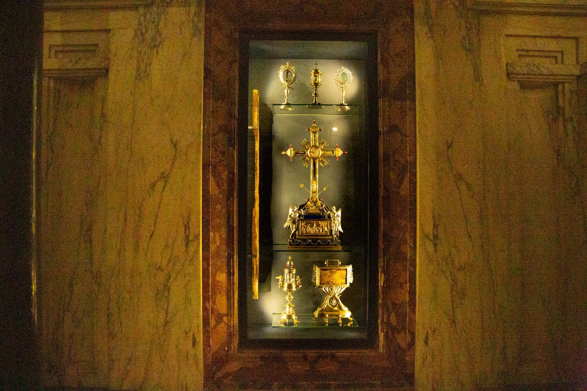 St. Peter's Basilica in Vatican City, seen from afar, with its iconic dome and framed by trees.